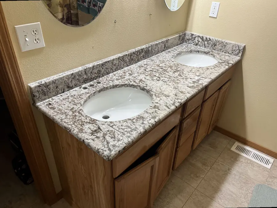 Speckled granite countertop on a bathroom vanity
