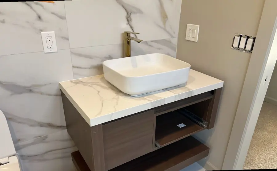Large-format porcelain slab used as a wall and vanity surface