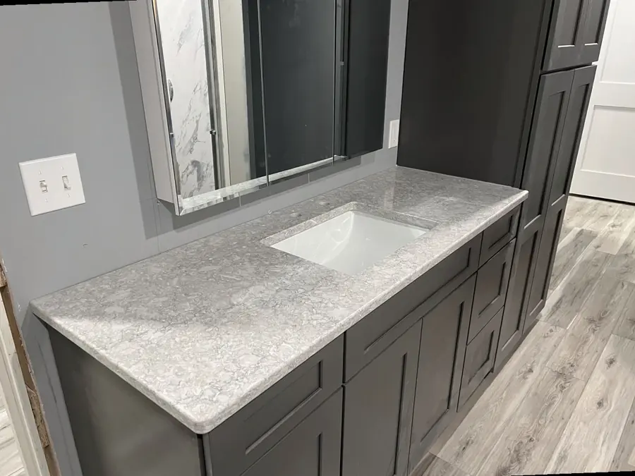 Close-up of a polished stone countertop edge and undermount sink