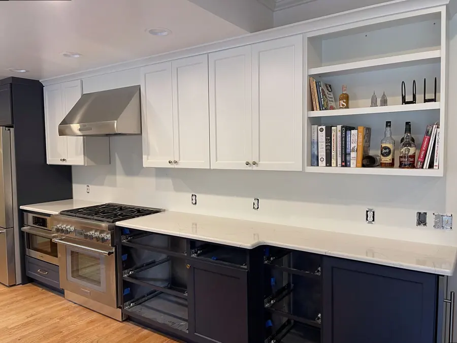 Full countertop run along a range wall with navy cabinets